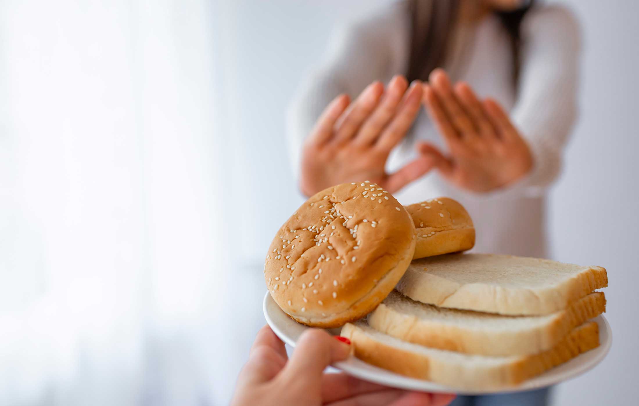 Point of view handing a plate of bread to a faceless person who is rejecting the plate