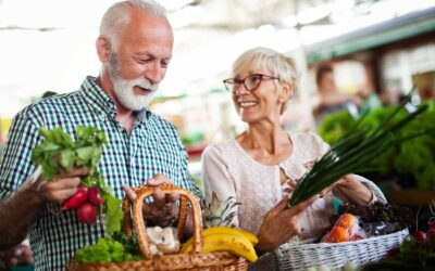 Elderly couple with wicker baskeds full of fresh produce